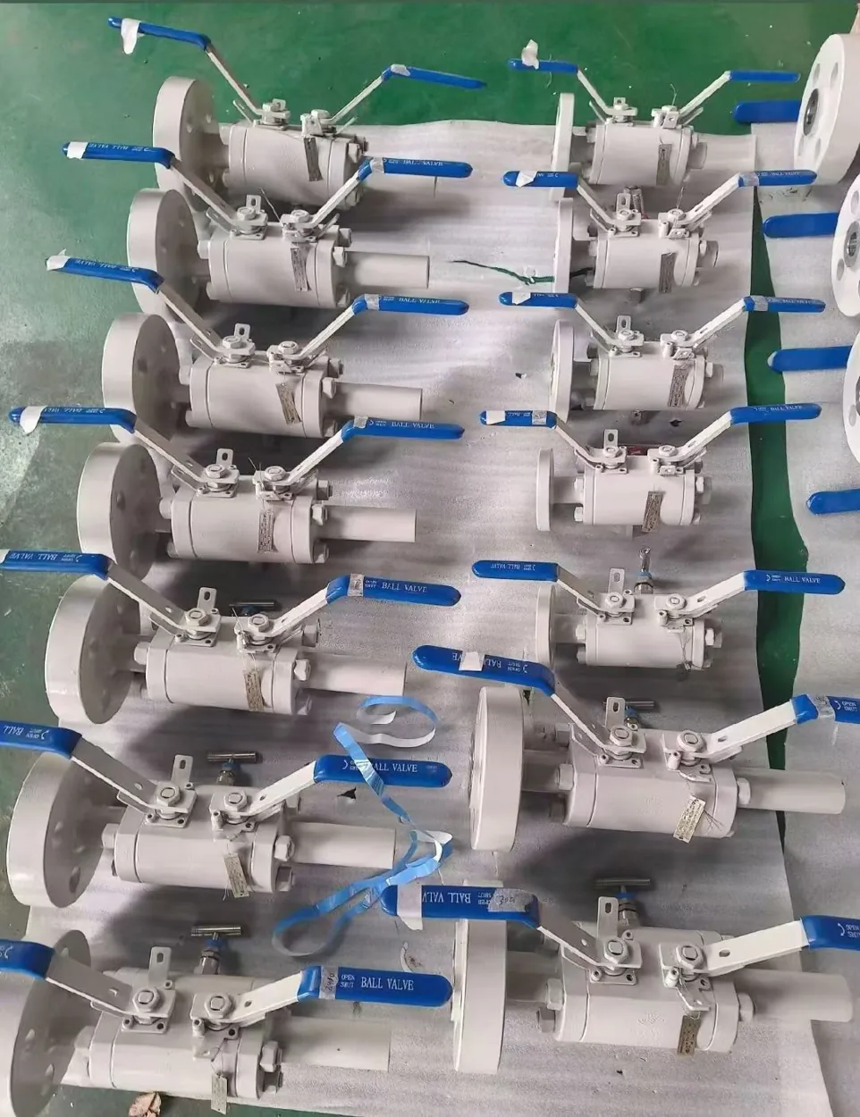 Small flanged lever-operated stainless steel ball valves arranged for dispatch